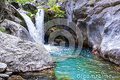 A beautiful mountain gorge with a river and a waterfall Stock Photo