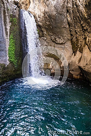 A beautiful mountain gorge with a river and a waterfall Stock Photo