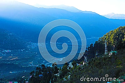 Beautiful mountain valley view with green trees Stock Photo