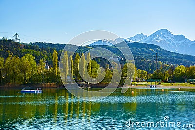 Beautiful Mountains and a lake in autumn. Baggersee Badesee Rossau, Innsbruck, Austria Stock Photo