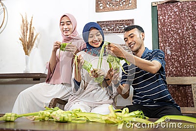 muslim family and friend making ketupat for eid fitr mubarak Stock Photo