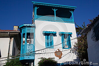 Beautiful narrow street in old town of Marmaris with plants and flowers on sunny day, Turkey. Blue balcony and door on Editorial Stock Photo