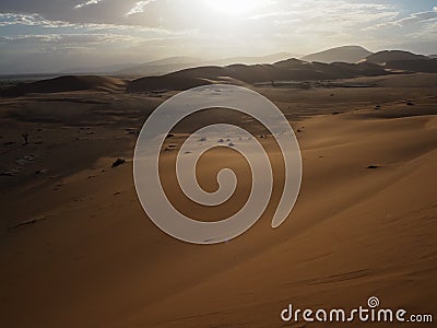 Beautiful natural rusty red sand dune and salt pan of vast desert landscape view with strong sunlight, Sossus, Namib desert Stock Photo