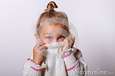 Beautiful natural young shy girl with smiling eyes wearing knitted sweater Stock Photo