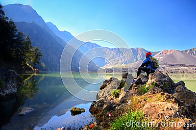 Beautiful nature background with unidentified hiker at Segara Anak Lake in early morning. Editorial Stock Photo