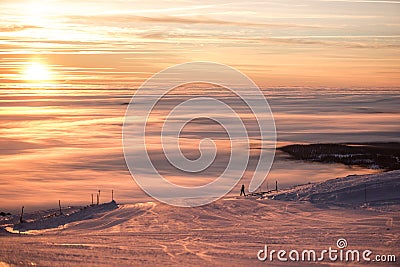 Breathtaking sunset, amazing sky, clouds, dreaming and skiing, relaxing on top of the mountain. Stock Photo