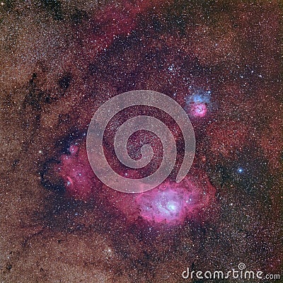 Beautiful nebulae in rich Milky way star field in the constellation Sagittarius including M8 the Lagoon nebula, M20 the Triffid ne Stock Photo