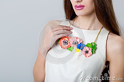 Beautiful necklace bizhueriya of flowers around the neck of a beautiful elegant girl Stock Photo