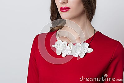 Beautiful necklace handmade flower orchid on the neck of the girl on a white background Stock Photo