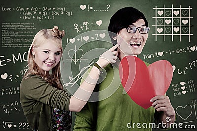 Beautiful nerd girl and guy in love at school Stock Photo
