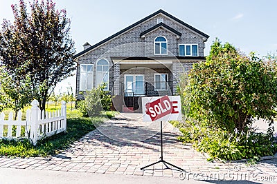 beautiful new house with sign sold standing Stock Photo