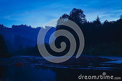 Beautiful night near a lake in the mountains Stock Photo