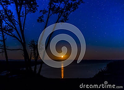 Beautiful night scene with moonshine over water Stock Photo