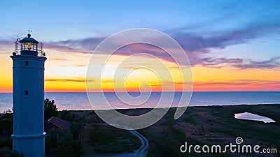 Beautiful nightly seascape with lighthouse and moody sky at the sunset Stock Photo