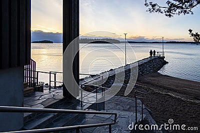 Beautiful northern landscape scenery of Gulf of Finland with morning skyline at dawn in Finland. Sandy shore with stone pier Stock Photo