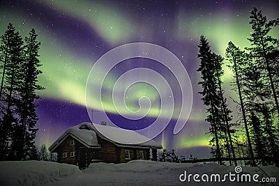 Beautiful Northern Lights Aurora Borealis in the night sky over winter Lapland landscape, Finland, Scandinavia Stock Photo