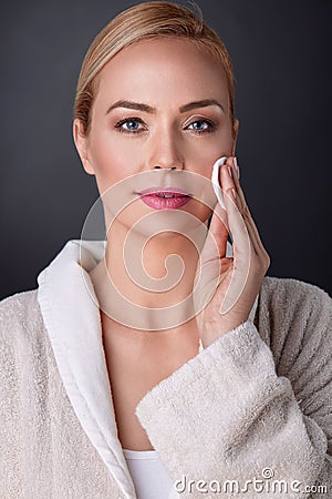 Beautiful nourished woman cleaning her face Stock Photo