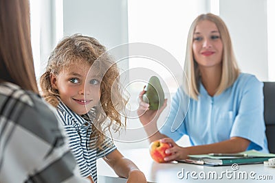 Nurse holds apple and avocado, healthy diet plan concept Stock Photo