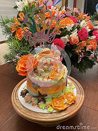 A beautiful ocean themed cake with orange roses Stock Photo