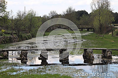 Beautiful and old stone bridge very old that allows us to pass the river Stock Photo