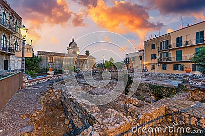 Beautiful old town of Taormina with small streets, flowers. Architecture with archs and old pavement in Taormina. Colorful narrow Stock Photo