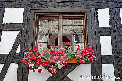 Beautiful old window frame with flower box. Stock Photo