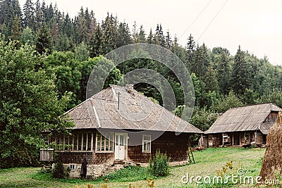 beautiful old wooden cabin cottage at mountains and woods, summer countryside, travel explore concept Stock Photo