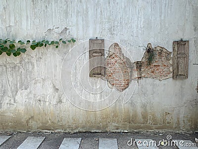 Beautiful orange brick with cracks old style on cement walls with green leave, abstract art background and vintage wallpaper Stock Photo