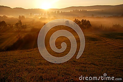 Beautiful orange sunrise and fog Stock Photo