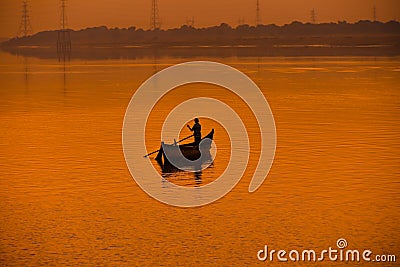 beautiful orange sunset landscape with fisherman on the small boat Editorial Stock Photo