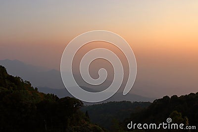 Beautiful orange and yellow sunset and layers of silhouettes mountain in Chiang Mai , Thailand Stock Photo