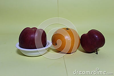 Beautiful oranges and apple on bowl Stock Photo