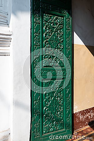 Beautiful ornate carvings on the green door of the Portuguese era Holy Spirit church in the old Editorial Stock Photo