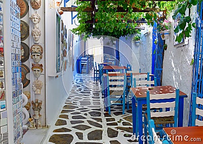 Beautiful outdoor cafe on the street on Naxos town in Greece. Stock Photo