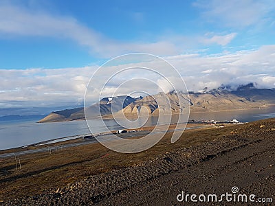 Beautiful overview photo of parts of longyear city airport with mighty mountains and sea Stock Photo
