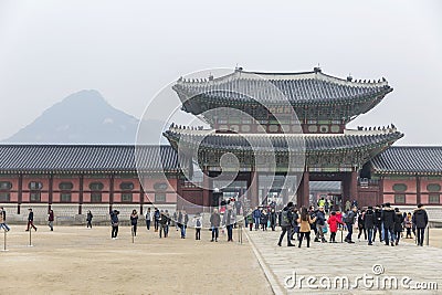 A beautiful pagoda and people walking at the entrance to a popular park in an Asian city. History, religion and architecture. Editorial Stock Photo