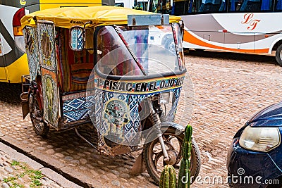 Beautiful painting three wheels vehicle parking in Pisac Editorial Stock Photo