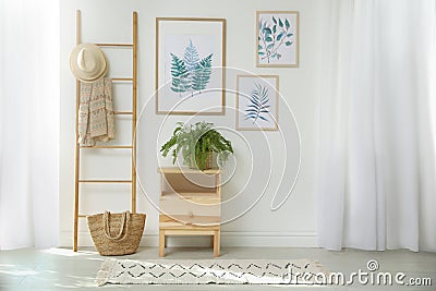 Beautiful paintings and plant at home. Idea for interior Stock Photo