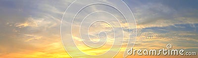 Beautiful panorama of orange and yellow cloudscapes at sunrise/sunset on a blue sky in high resolution Stock Photo