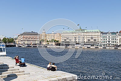 Beautiful panorama promenade in Stogkolm, Sweden. People tourists sit on benches, look at the water on a sunny day Editorial Stock Photo