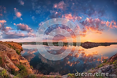 Beautiful panoramic landscape with colorful cloudy sky, lake and Stock Photo