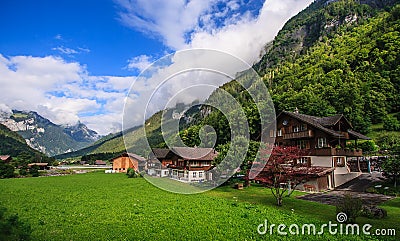 Beautiful panoramic postcard view of picturesque rural mountain scenery in the Alps with traditional old alpine mountain chalets Stock Photo