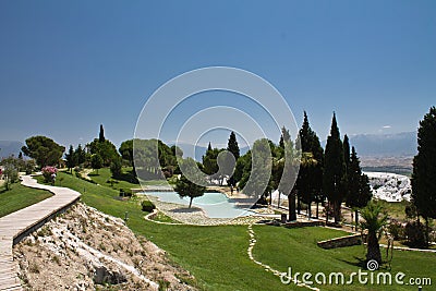 Beautiful panoramic sight of natural hot limestone spring pools in pamukkale park with pine trees, turkey Editorial Stock Photo