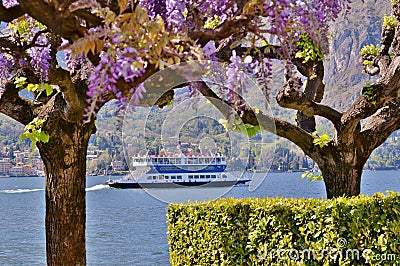 Beautiful panoramic view to ferry boat moving on the lake Como at Bellagio in early spring sunny day. Stock Photo