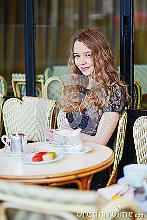 Beautiful Parisian woman in cafe Stock Photo