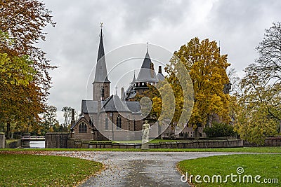 From this beautiful park in autumn colors you have a beautiful view of the chapel of castle De Haar Editorial Stock Photo