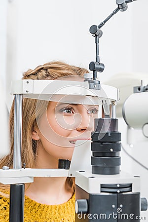 beautiful patient examining her eyes with slit lamp Stock Photo