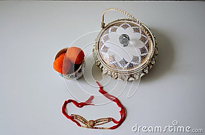 Beautiful pattern on decorative pieces of art. container with rakhis and ladoos. .Gift box. Stock Photo