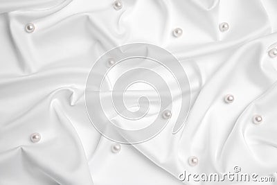 Beautiful pearls on white silk, flat lay Stock Photo