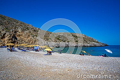 The beautiful pebbled beach of Chalkos in Kythera. Amazing scenery with crystal clear water and a small rocky gulf in Kythera Editorial Stock Photo